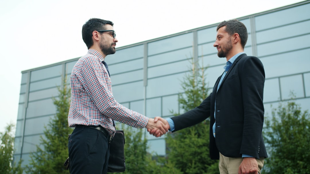 Real estate advisors shaking hands after a successful deal